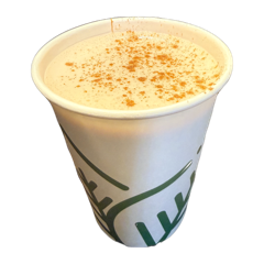 A hot chai dusted with cinnamon in a paper cup