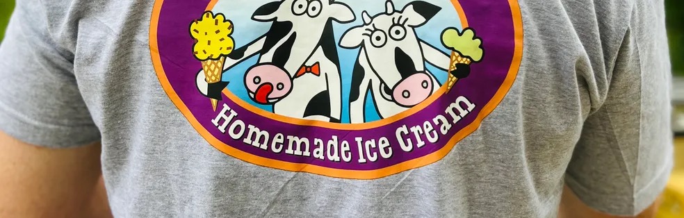 A gray Morton’s Moo T-shirt printed with the cow logo