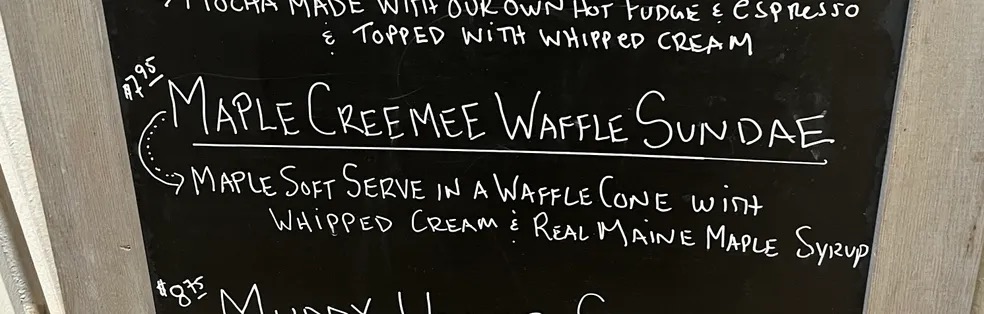 A chalkboard listing the Maple Creemee Waffle Sundae