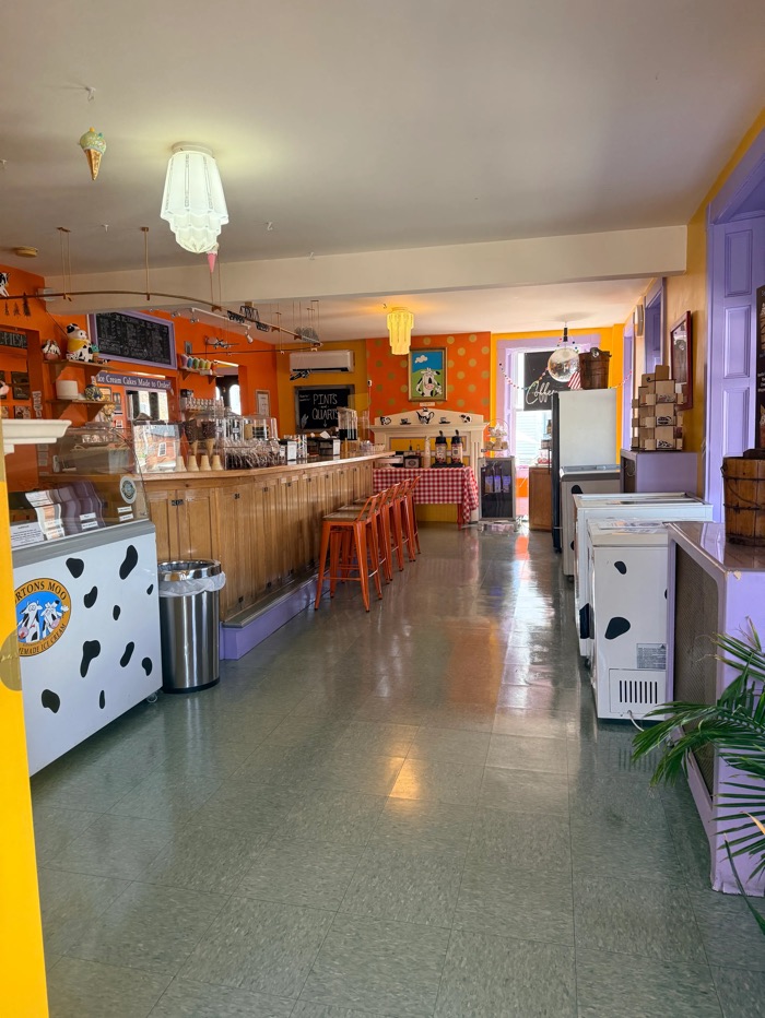 The long parlor at Morton’s Moo with its wooden counter, lilac trim and cow-print freezers